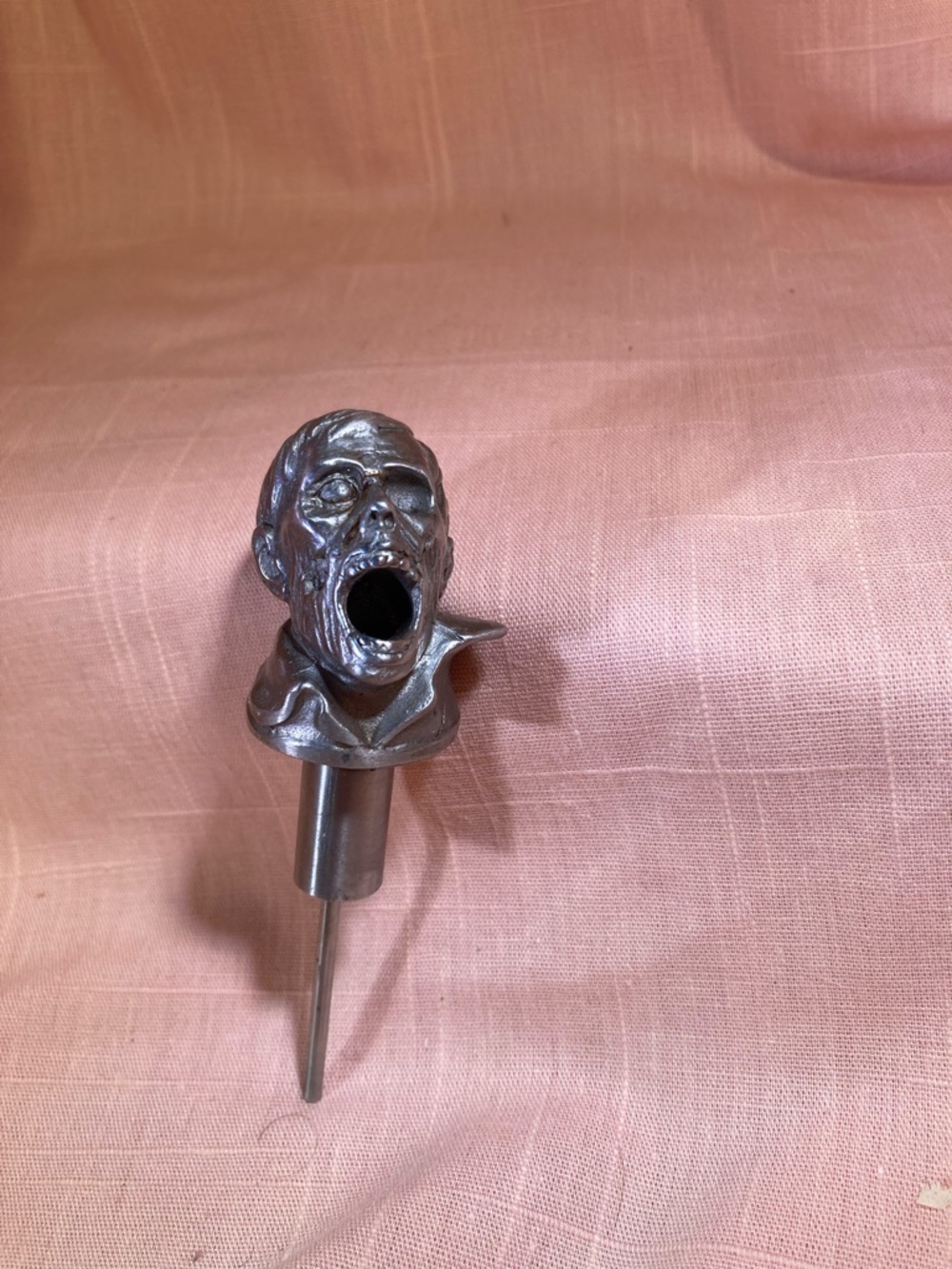 Metal zombie bottle spout for wine or oil.